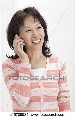 Wife, Woman using mobile phone and laughing View Large Photo Image Picture - Wife, Woman using mobile phone and laughing. Fotosearch