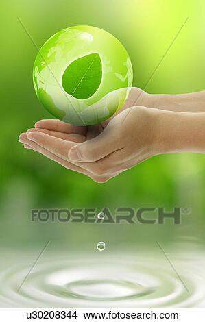 Picture - Lohas, Environmental Conservation, Digitally generated image of human hand holding a green leaf. Fotosearch