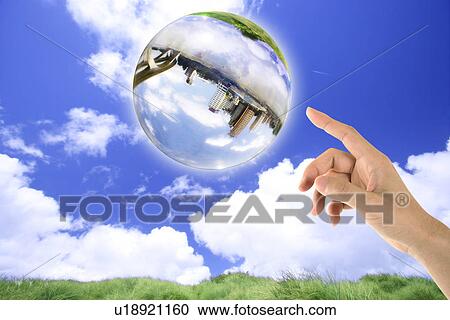 Stock Image - Lohas, Environmental Conservation, Digitally generated image of human hand pointing at the sphere with building. Fotosearch
