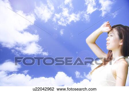 Lohas, Environmental Conservation, Digitally generated image of woman looking away in the blue sky View Large Photo Image Stock Image - Lohas, Environmental Conservation, Digitally generated image of woman looking away in the blue sky. Fotosearch