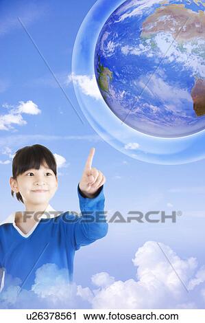 Stock Image - Lohas, Environmental Conservation, Little girl pointing at the earth with smile. Fotosearch