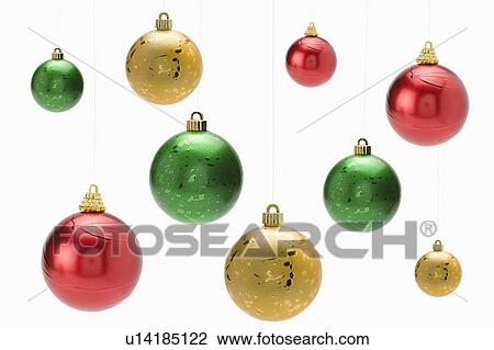 Stock Image - Christmas baubles hanging mid-air. Fotosearch