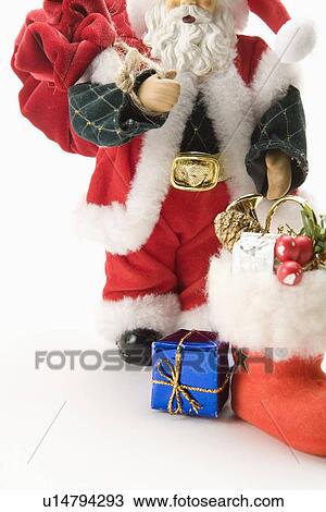 Figurine of Santa Claus, carrying gifts and a bag View Large Photo Image Stock Image - Figurine of Santa Claus, carrying gifts and a bag. Fotosearch