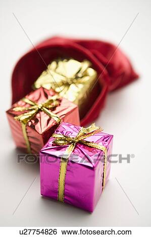 Gifts out of a red sack View Large Photo Image Stock Photograph - Gifts out of a red sack. Fotosearch