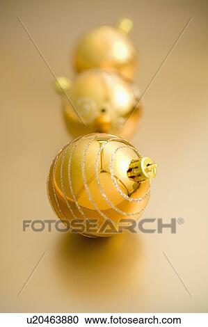 Three golden Christmas baubles View Large Photo Image Stock Image - Three golden Christmas baubles. Fotosearch
