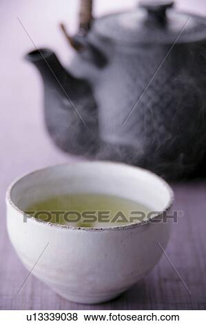 A cup of green tea and teapot View Large Photo Image Stock Photo - A cup of green tea and teapot. Fotosearch