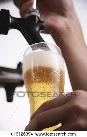 A man pouring beer into glass View Large Photo Image Picture - A man pouring beer into glass. Fotosearch