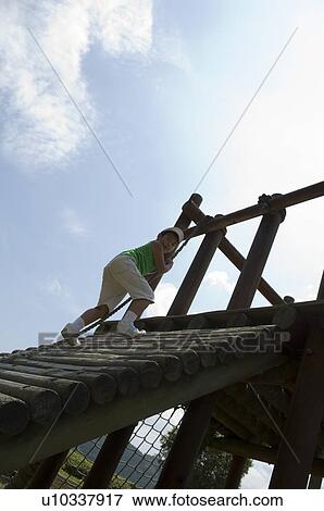 Boy playing in playground View Large Photo Image Stock Photo - Boy playing in playground. Fotosearch
