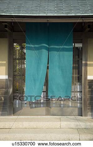 Stock Image - Cloth hanging outside lattice door. Fotosearch