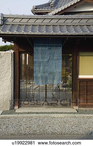 Stock Image - Cloth hanging outside lattice door. Fotosearch
