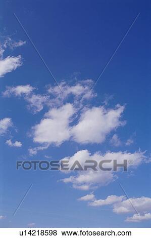 Stock Photo - Clouds in clear blue sky. Fotosearch
