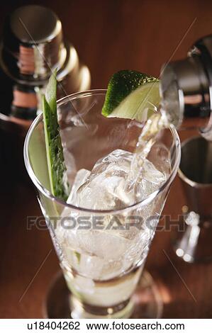 Cocktail pouring into glass View Large Photo Image Stock Image - Cocktail pouring into glass. Fotosearch