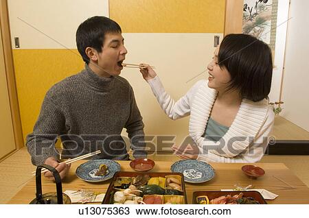 Stock Image - Couple having New Year's Day meal. Fotosearch