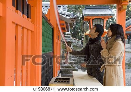 Couple praying at shrine View Large Photo Image Stock Image - Couple praying at shrine. Fotosearch