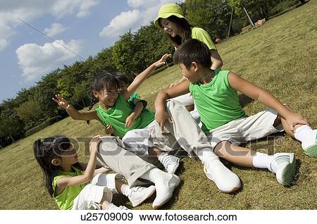 Family playing in field View Large Photo Image Stock Photo - Family playing in field. Fotosearch