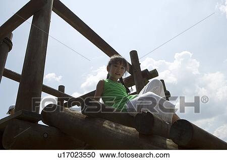 Stock Image - Girl playing in playground. Fotosearch