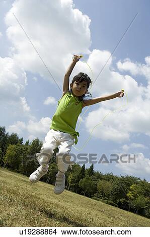Girl playing with jump rope View Large Photo Image Picture - Girl playing with jump rope. Fotosearch