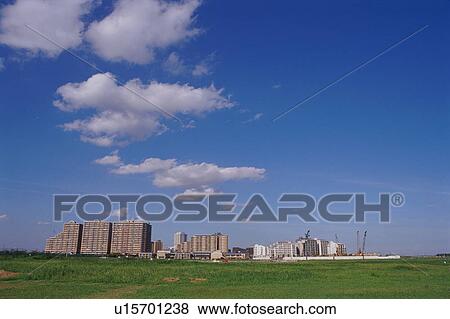 Green field with apartments in background View Large Photo Image Stock Photo - Green field with apartments in background. Fotosearch
