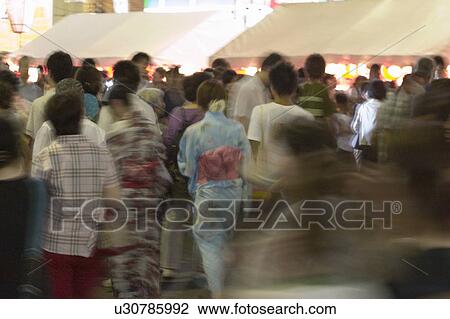 Group of people visiting summer festival in Japan View Large Photo Image Stock Image - Group of people visiting summer festival in Japan. Fotosearch