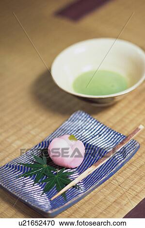 Stock Image - Japanese sweets and a cup of green tea. Fotosearch