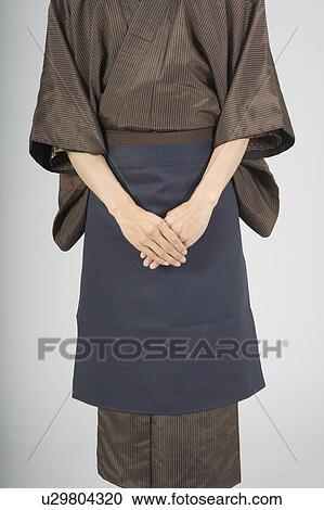 Stock Image - Man wearing kimono with apron. Fotosearch