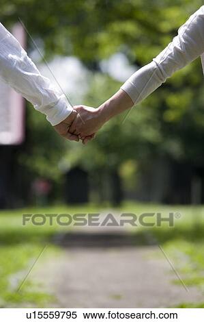 Stock Photography - Mature couple holding hands. Fotosearch