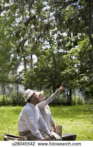 Mature couple sitting on bench View Large Photo Image Stock Image - Mature couple sitting on bench. Fotosearch