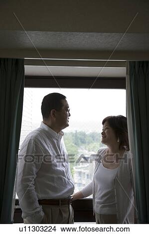 Picture - Mature couple standing on balcony. Fotosearch