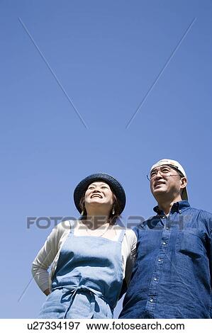 Mature couple standing side by side View Large Photo Image Stock Photo - Mature couple standing side by side. Fotosearch