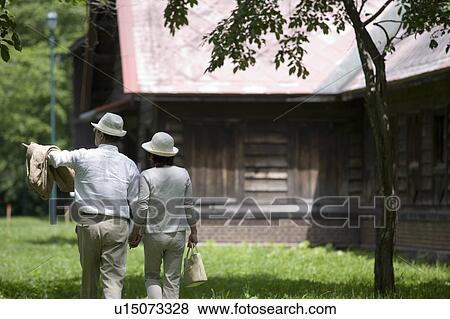Stock Photo - Mature couple walking in park. Fotosearch