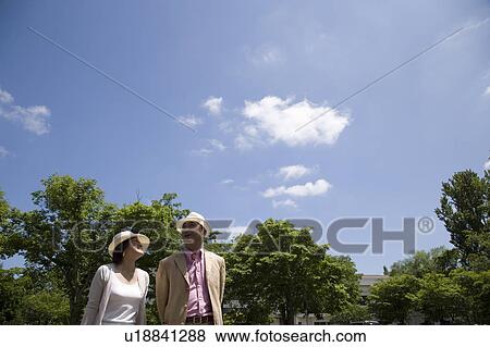 Mature couple walking View Large Photo Image Stock Photo - Mature couple walking. Fotosearch