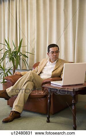 Stock Image - Mature man using computer. Fotosearch