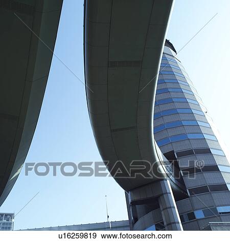 Stock Photo - Motorway coming out of a building in Osaka, Japan. Fotosearch