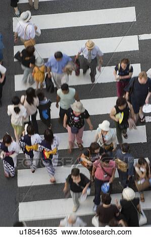 Stock Photography - People crossing street in Japan. Fotosearch