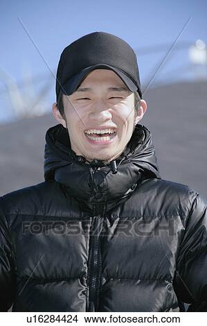Picture - Portrait of a young man smiling. Fotosearch