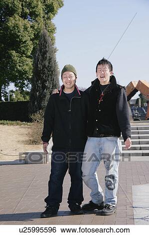 Stock Photograph - Portrait of young men smiling. Fotosearch
