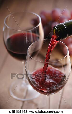 Red wine pouring into wineglass View Large Photo Image Stock Photo - Red wine pouring into wineglass. Fotosearch