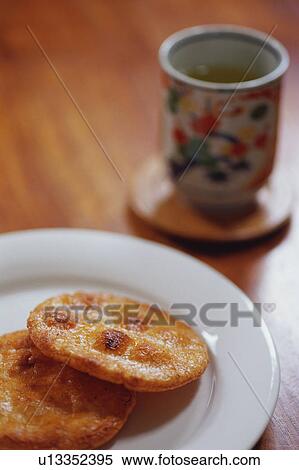 Rice crackers and a cup of green tea View Large Photo Image Stock Photography - Rice crackers and a cup of green tea. Fotosearch