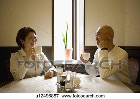 Stock Photo - Senior couple drinking coffee. Fotosearch