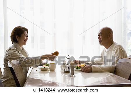 Picture - Senior couple having breakfast. Fotosearch