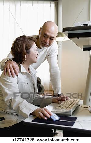 Senior couple using computer View Large Photo Image Stock Photo - Senior couple using computer. Fotosearch