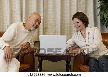 Senior couple using computer View Large Photo Image Stock Photograph - Senior couple using computer. Fotosearch