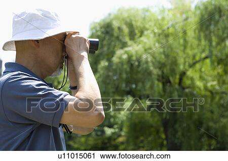 Senior man using binoculars View Large Photo Image Stock Image - Senior man using binoculars. Fotosearch