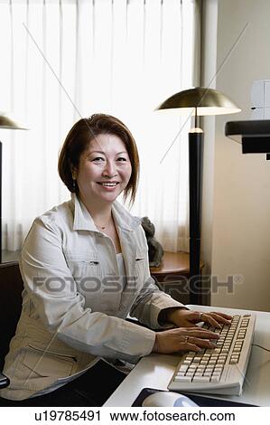 Stock Image - Senior woman using computer. Fotosearch