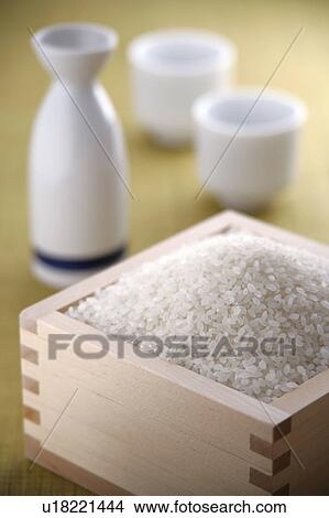 Uncooked rice and sake cups View Large Photo Image Picture - Uncooked rice and sake cups. Fotosearch