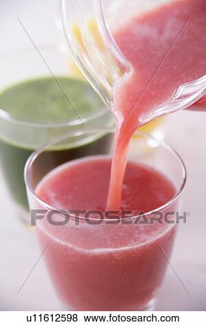 Vegetable juice pouring into glass View Large Photo Image Stock Photo - Vegetable juice pouring into glass. Fotosearch