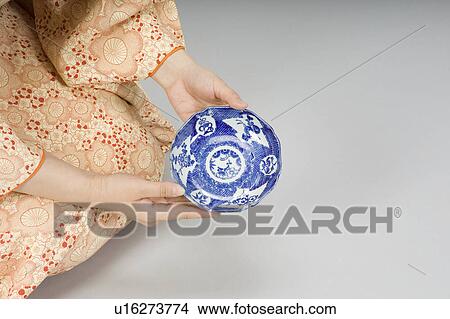 Picture - Woman examining plate. Fotosearch