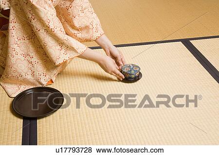 Stock Photo - Woman serving cup of tea. Fotosearch