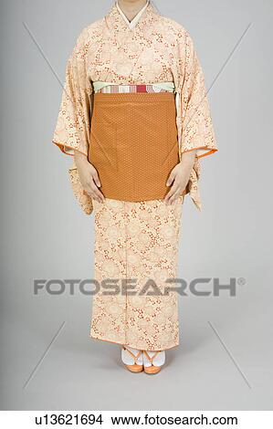 Picture - Woman wearing kimono with apron. Fotosearch