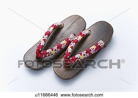 Stock Photograph - A pair of Geta sandals, high angle view, white background. Fotosearch